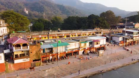 holy ganges riverbank filled with religious temples at evening aerial shot video is taken at rishikesh uttrakhand india on mar 15 2022