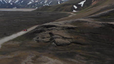 Aerial-view-4x4-vehicle-exploring-Iceland-remote-destination.-Safety-and-security.-Adventure-and-exploration.-Car-offroad-drone-view-driving-muddy-path-in-Iceland.-Commercial-insurance