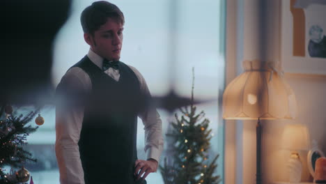 sad young man standing at home during christmas