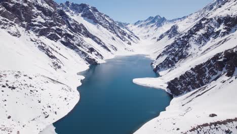 andes mountain range with lake del inca in portillo, chile in winter - aerial drone shot