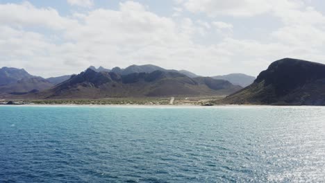 Drone-flies-high-towards-Tecolote-Beach,-Baja,-Mexico