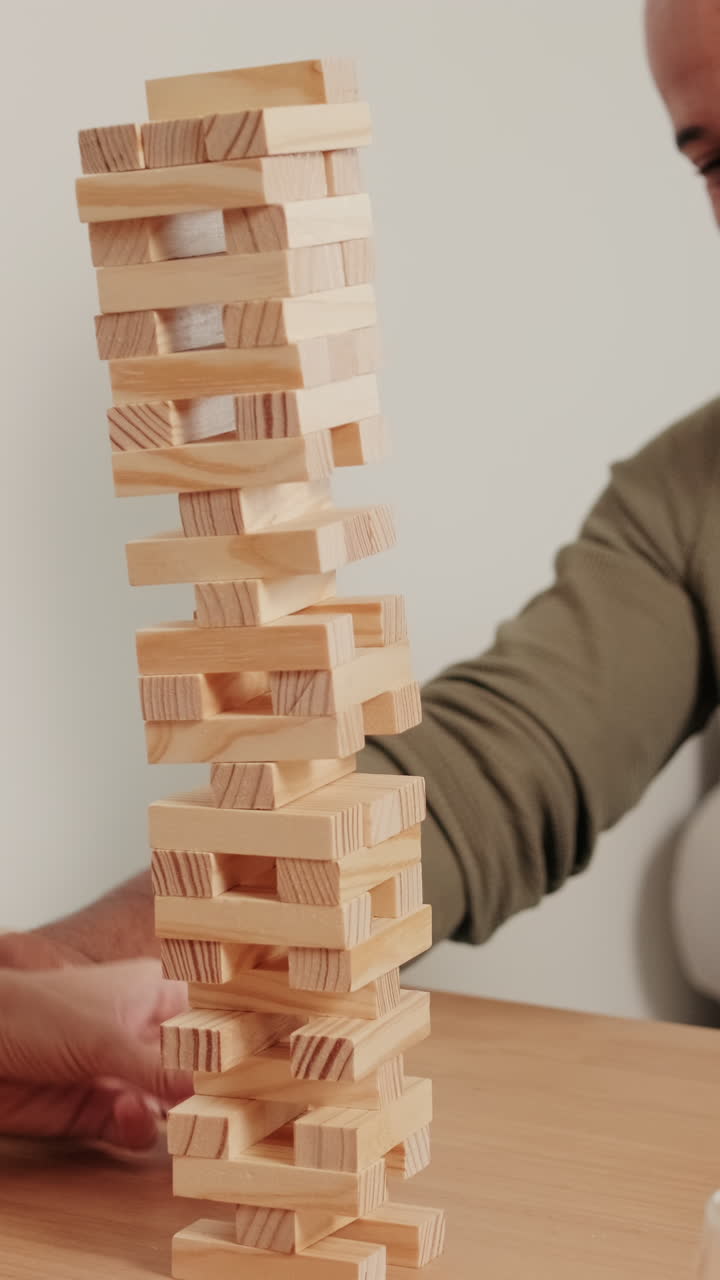 couple playing board games, playing Jenga and Laughing at Home