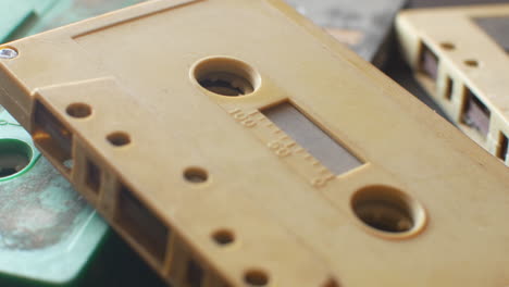 audio cassettes on a table dolly-in extreme close-up shot