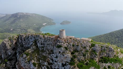 old ruined tower on the tip of an island mountain landscape surrounded by a blue ocean