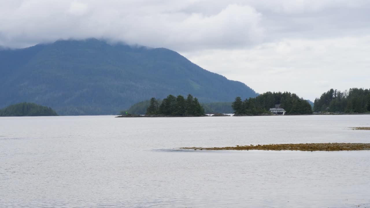 Beautiful landscape around Sitka, Alaska.Small rocky islands and mountain covered by clouds.