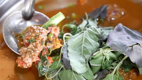 close up footage of hot and spicy beef clear soup curry with long curd beans and holy basil leaves, one of the delicious homemade dish in thailand