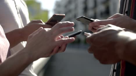 side view of young people using smartphones.