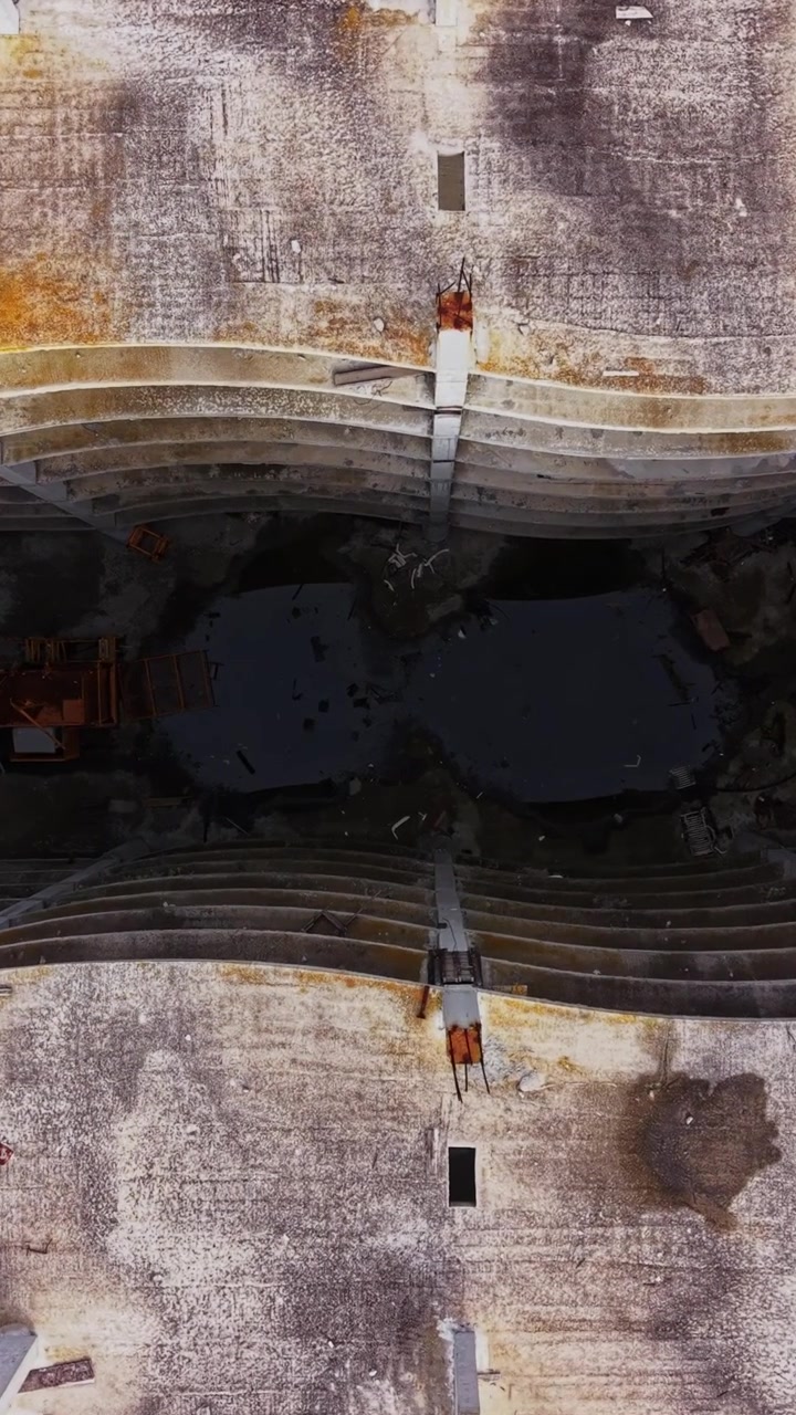 Exploring an abandoned structure from above in a green landscape