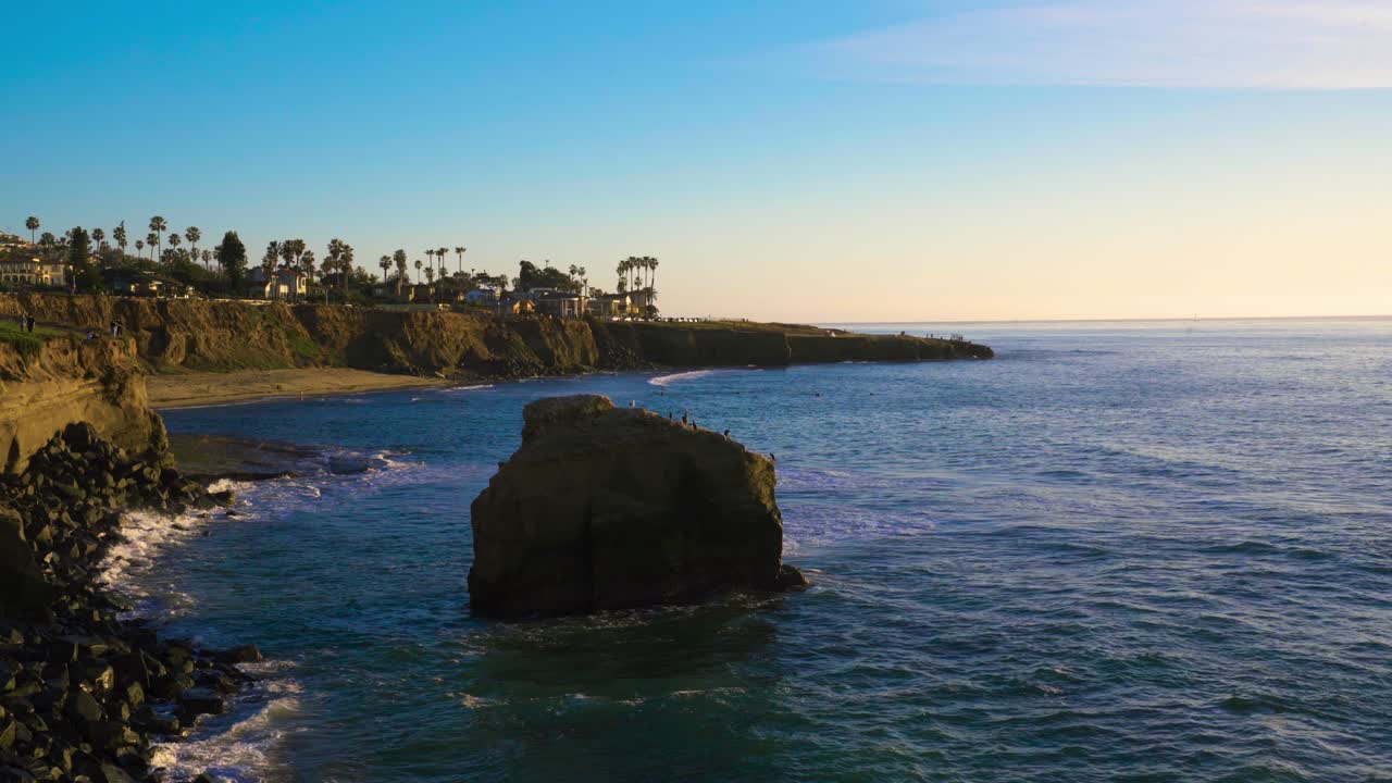 Ocean coastline houses along rocky sunset cliffs in beautiful southern California
