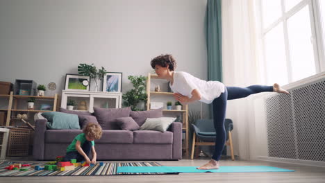 mother and son doing yoga at home