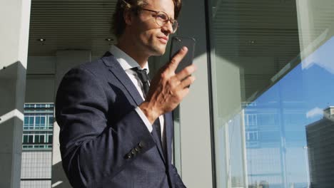 Businessman-on-smartphone-in-a-modern-office-building