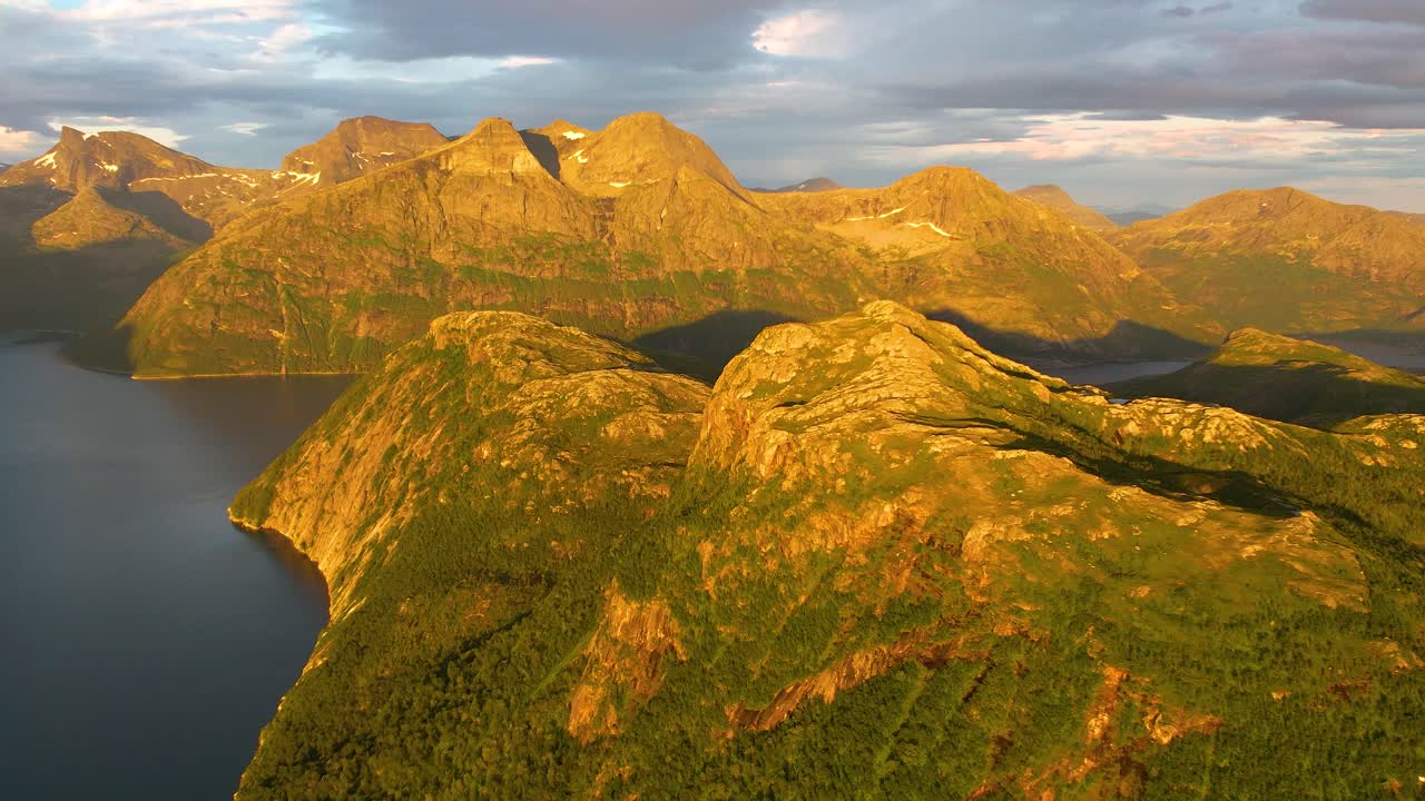 Discover the cinematic beauty of Finnkonakken's golden hour in 4K. Aerial footage showcases dramatic landscapes in warm, inviting light. Enhance your project with this high-quality stock.