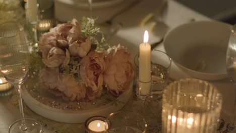 close up of bridal bouquet on table set for meal at wedding reception 1