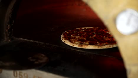 pizza baking in a wood-fired oven