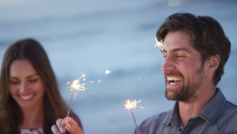 couple, sparkler and joy while celebrating