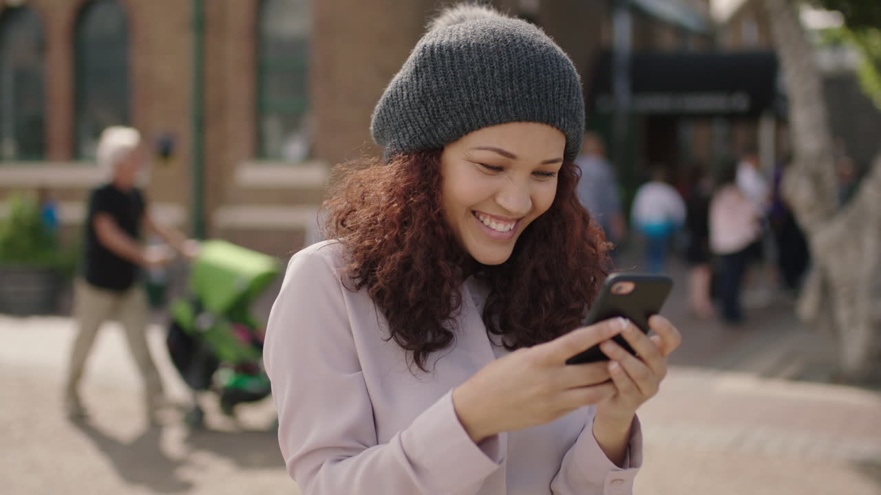 portrait of beautiful mixed race girl wearing beanie hat posing taking selfie photo using smartphone