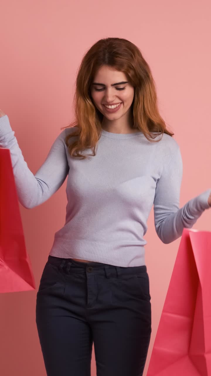 Happy young woman with many shopping bags. Vertical Footage