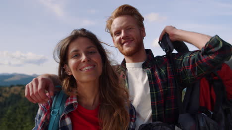 smiling couple hiking in mountains