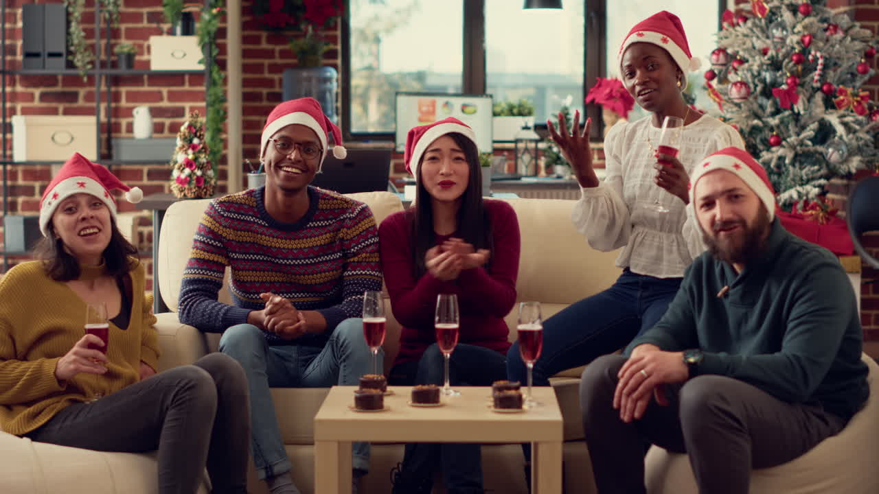 Diverse colleagues clinking wine glasses on videocall conference