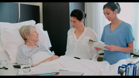 family visit to grandmother in hospital bed