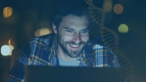 animation of scientific data over happy caucasian man using laptop