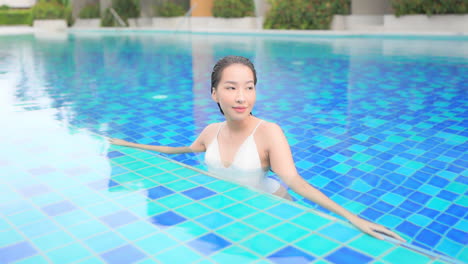 sexy exotic woman in blue swimming pool