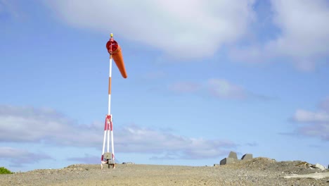 a windsock blowing next to an airport