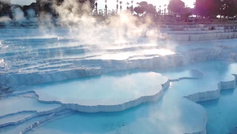 Steamy-blue-hot-springs,-mineral-waters,-forming-travertine-limestone-mineral-deposit-formations