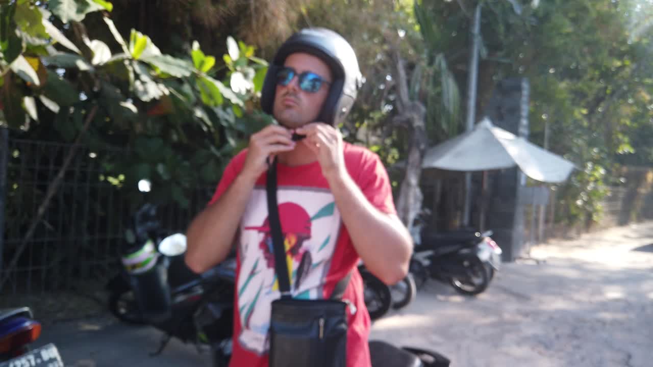 Man find his motor and trying to start. Beautiful couple exploring tropical Bali Indonesia island with motorbike. Paradise jungle finding happiness and freedom.