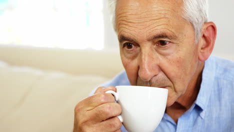 Mature-man-thinking-and-holding-a-cup