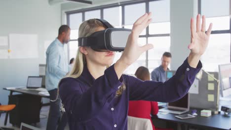 Businesswoman-using-VR-headset-in-modern-office