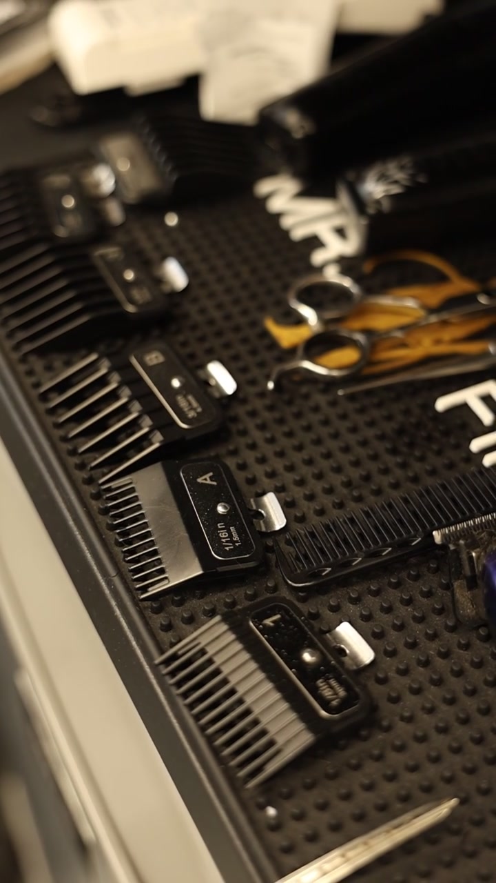 Barber Tools and Hair Clipper Guards Arranged on a Work Station