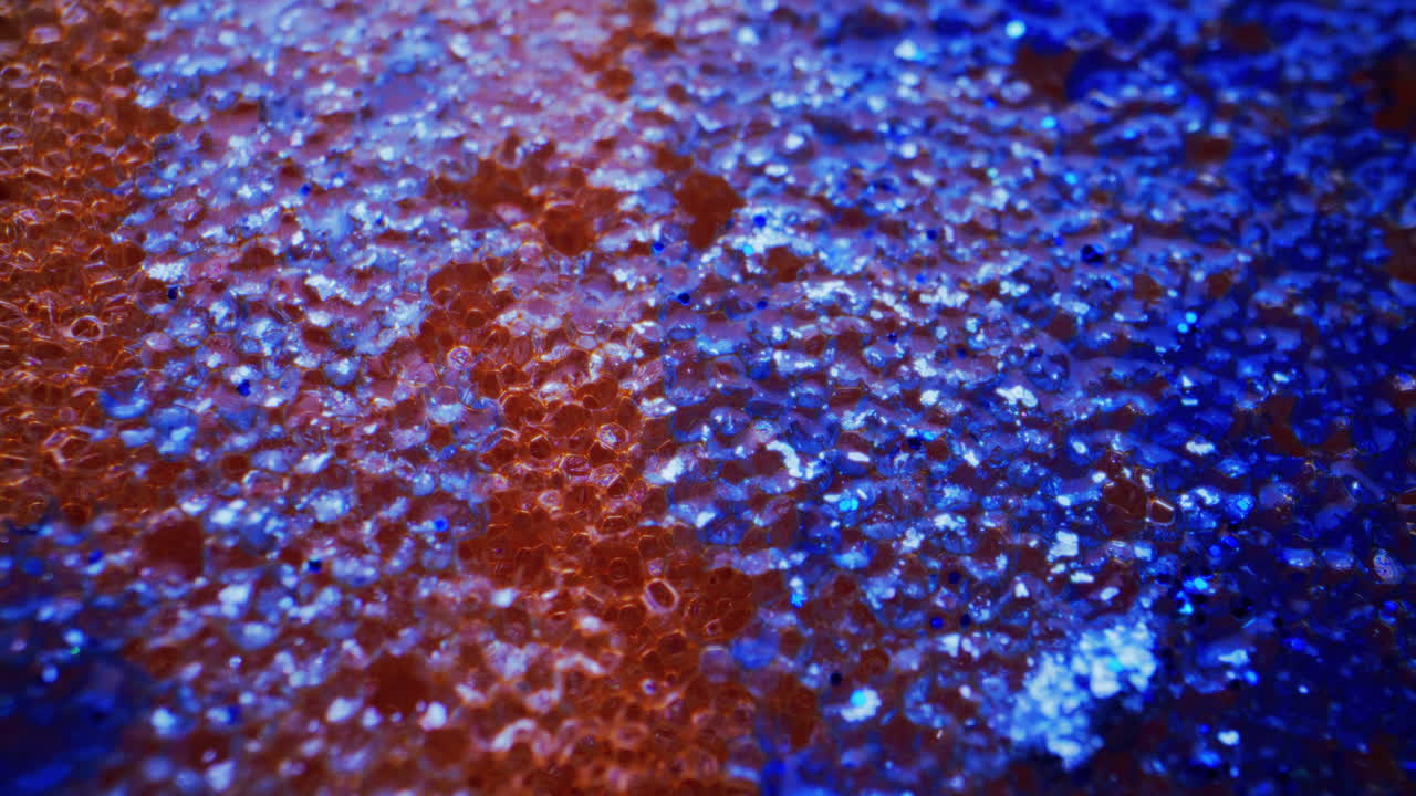 Close-up View of Textured Surface with Glitter and Gradient Colors