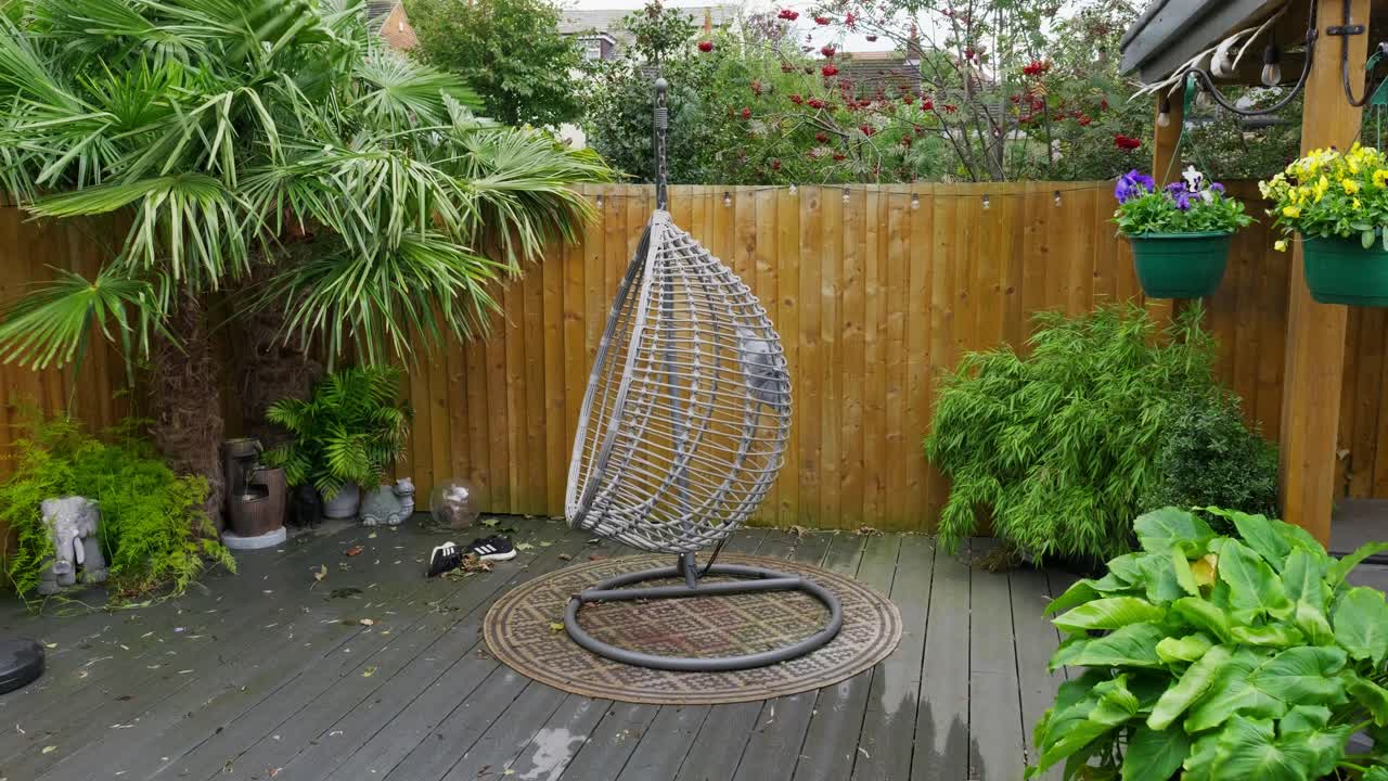 Minimalistic English garden with modern decking bamboo plants on a windy breezy day