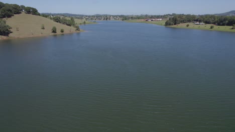 tranquil waters of lake tinaroo surrounded by lush greenery in yungaburra town, atherton tablelands, australia