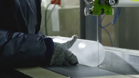 scientist cutting a core sample of ice in a laboratory for research