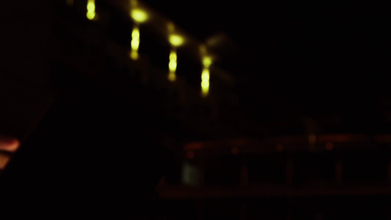 Woman tapping phone in dim room, play and message badges swarming, cursor clicking, checking media