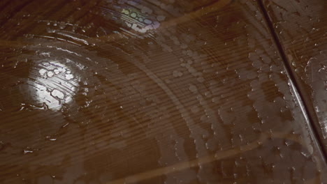 cleaning a wooden table with glass top