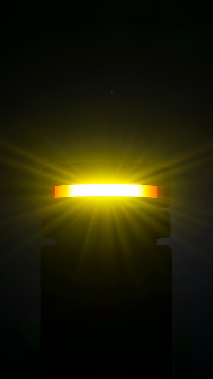 Vertical video: Powering ring light atop dark base casting speck and flares in studio stabilizing