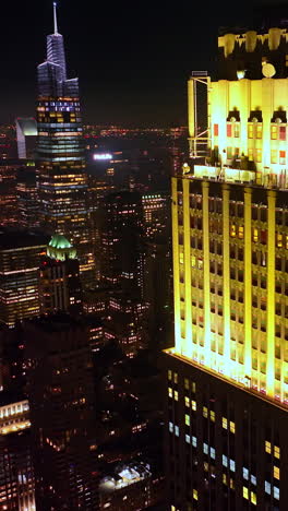 amazing beautifully-lit top of a skyscraper in new york. startling cityscape of metropolis at night. top view. vertical video