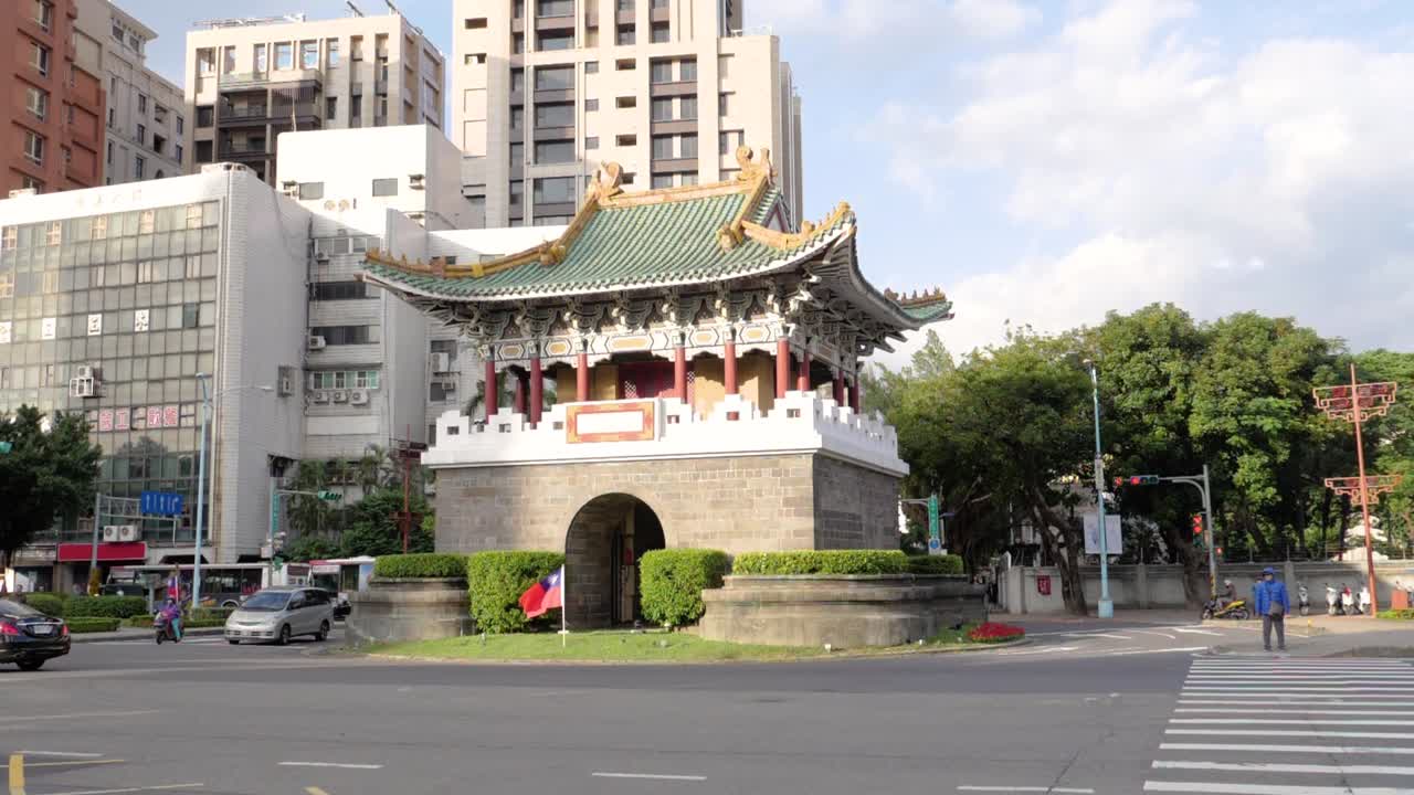Ultra slow motion shot of temple by road with traffic in Taipei, Taiwan - camera panning left