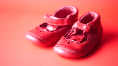 childrens shoes on red  background