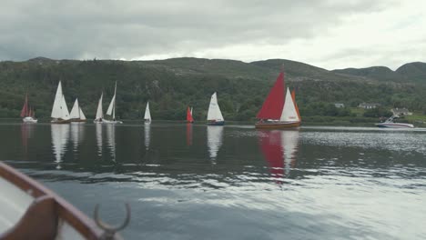 sailboats at starting line of sailing regatta