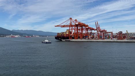 the shipping terminal and port in vancouver harbour with a sightseeing ferry