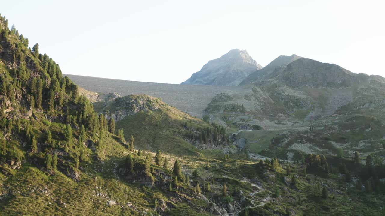 Wide-angle drone landscape of rugged alpine terrain in Kühtai, showing dramatic slopes and mountain textures. Ideal for travel and documentary visuals