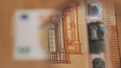 50 euro under magnifying glass
