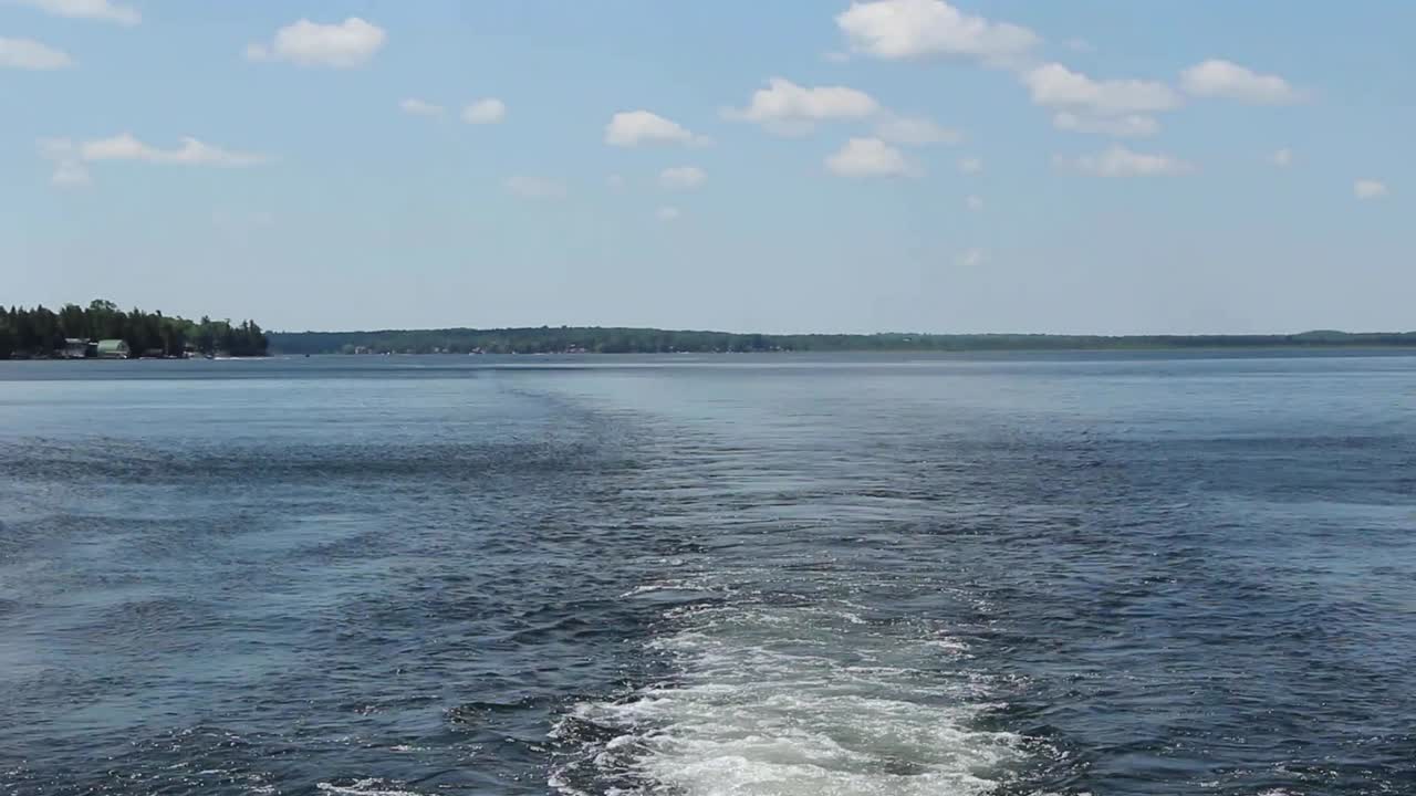 Wakes And Waves From The Motor Boat Cruising On The Calm Water In Kawartha Lakes, Ontario, Canada. - pan up