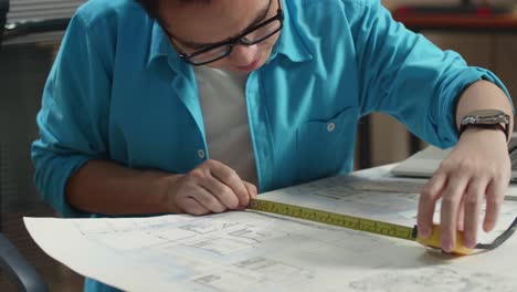 architect measuring house plan