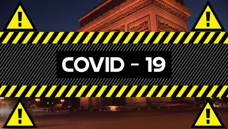 animation of the word covid-19 written on yellow over cityscape in the background.