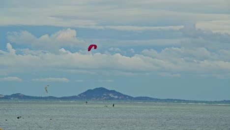 kiteboarding and fishing boats on the sea
